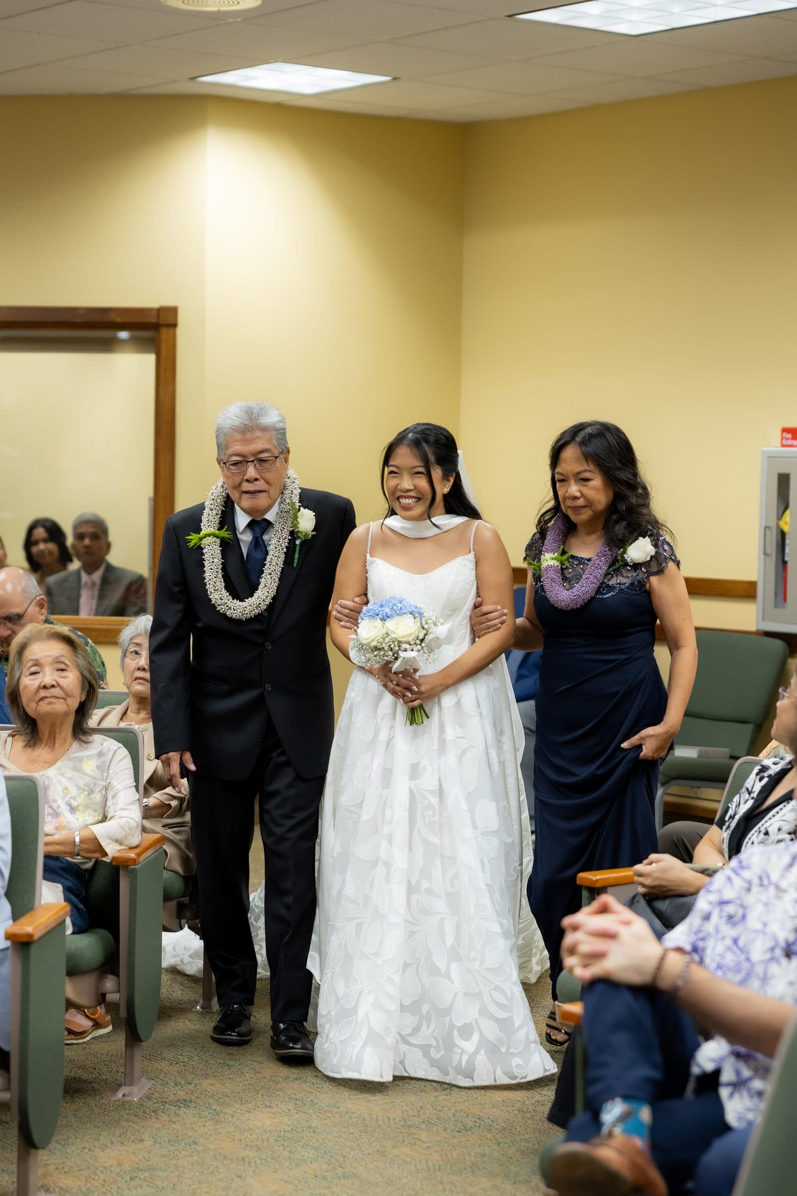Guests turn to watch Mia walk in with her family.